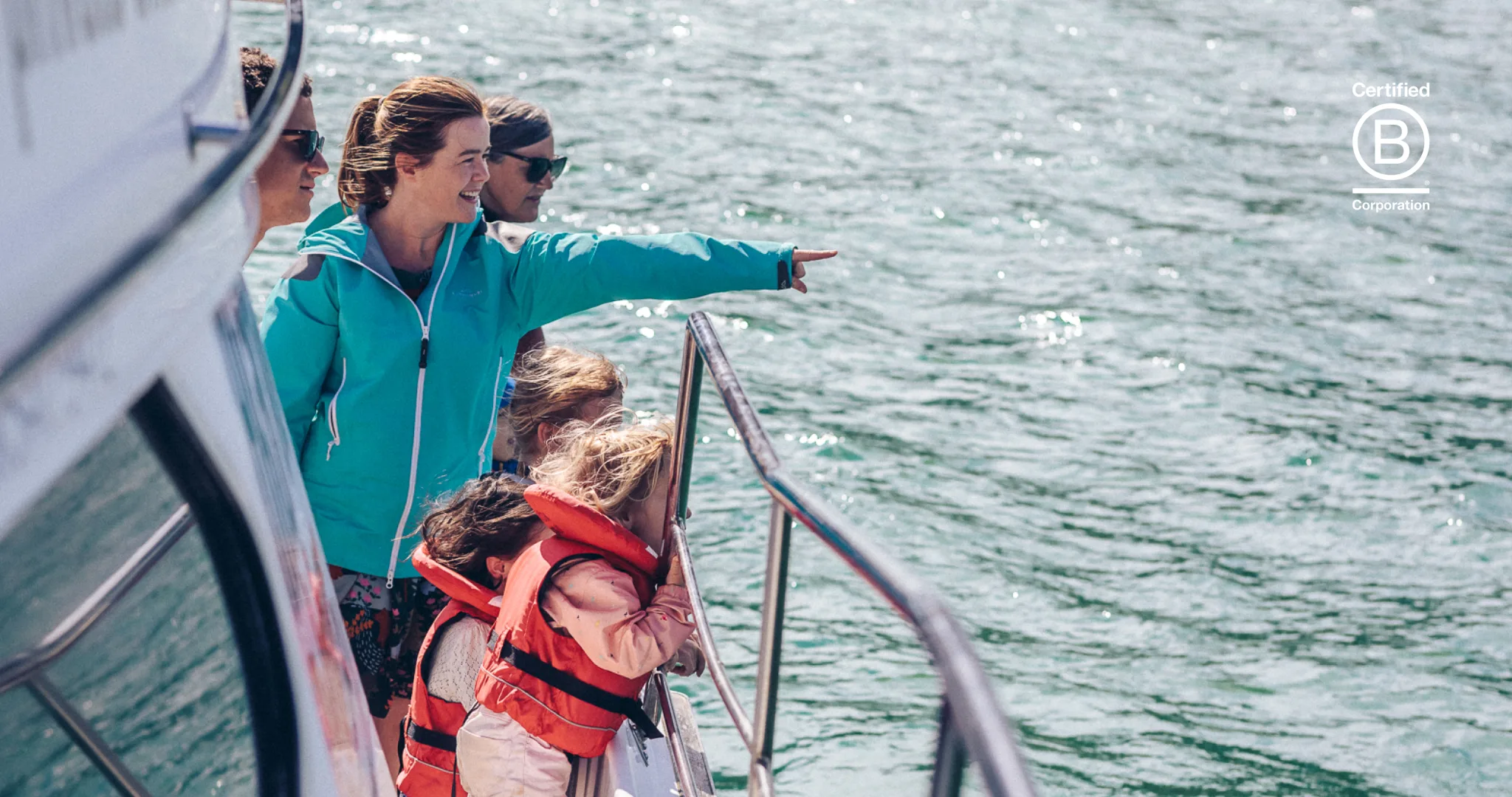 Family enjoying a dolphin-spotting cruise with Akaroa Dolphins