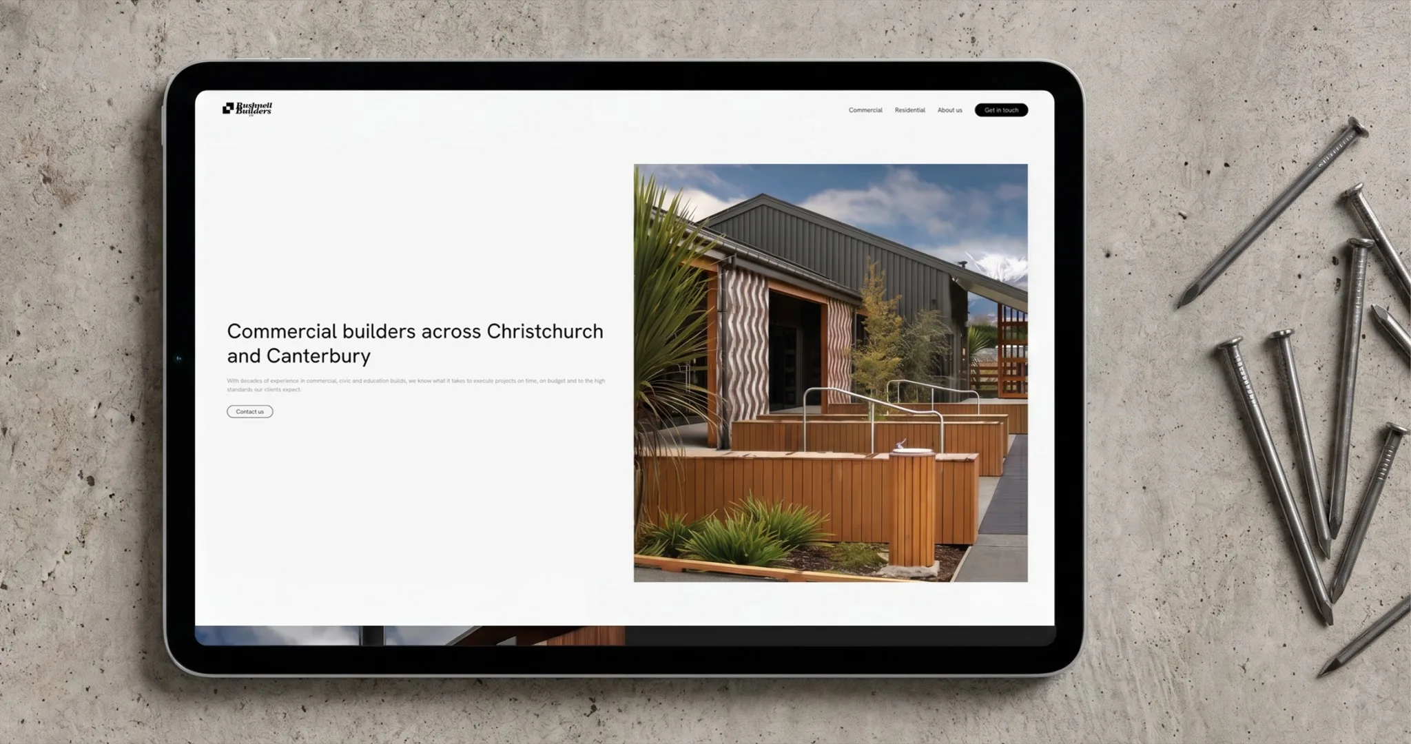 Bushnell Builders commercial builders page shown on a tablet
