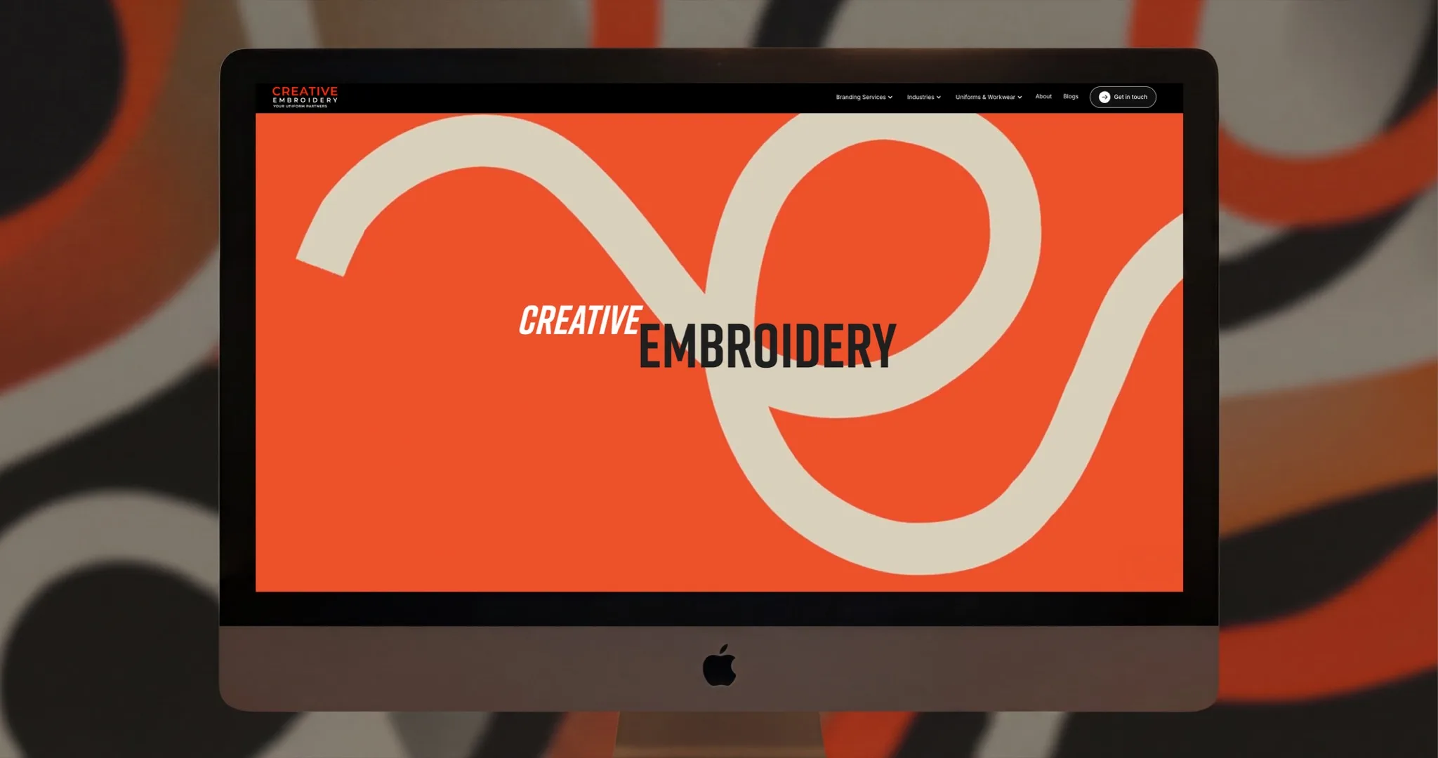 Creative Embroidery homepage shown on an iMac