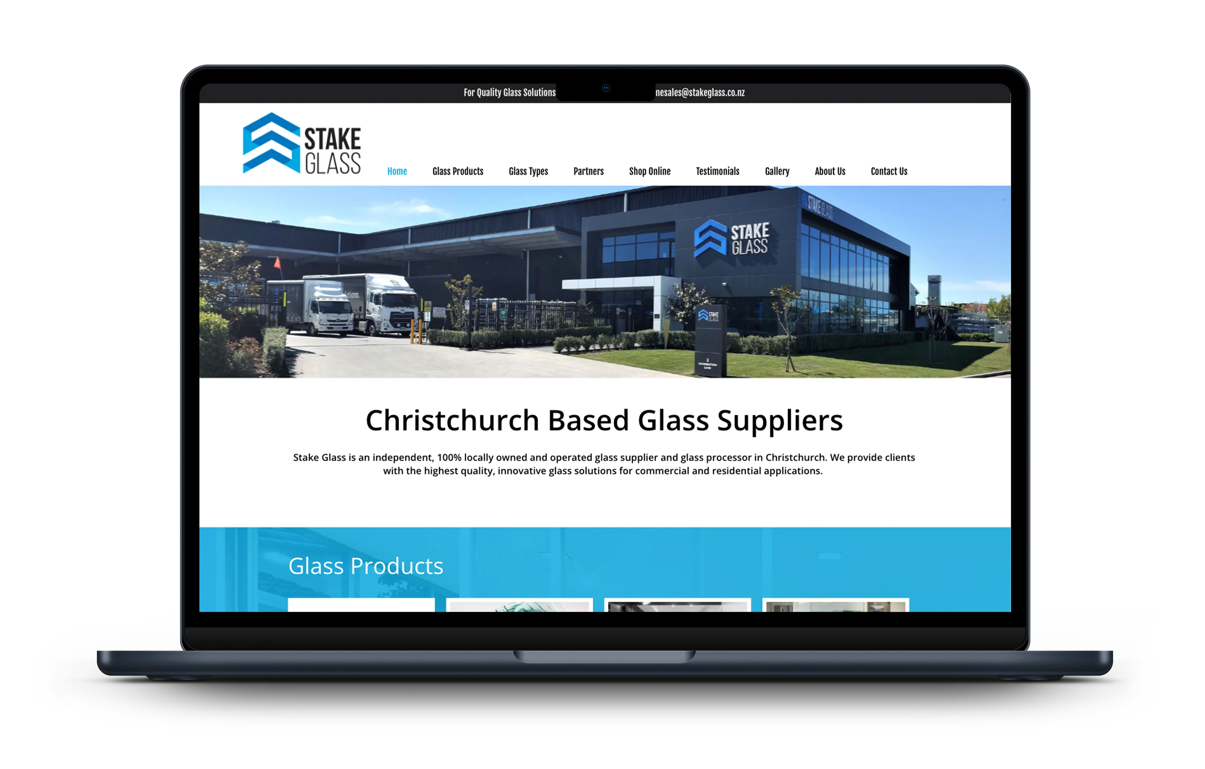 The previous Stake Glass website homepage, shown on a laptop